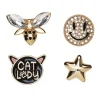 Pins, badges, 4 stk. gylne, svarte og blingete minibrosjer