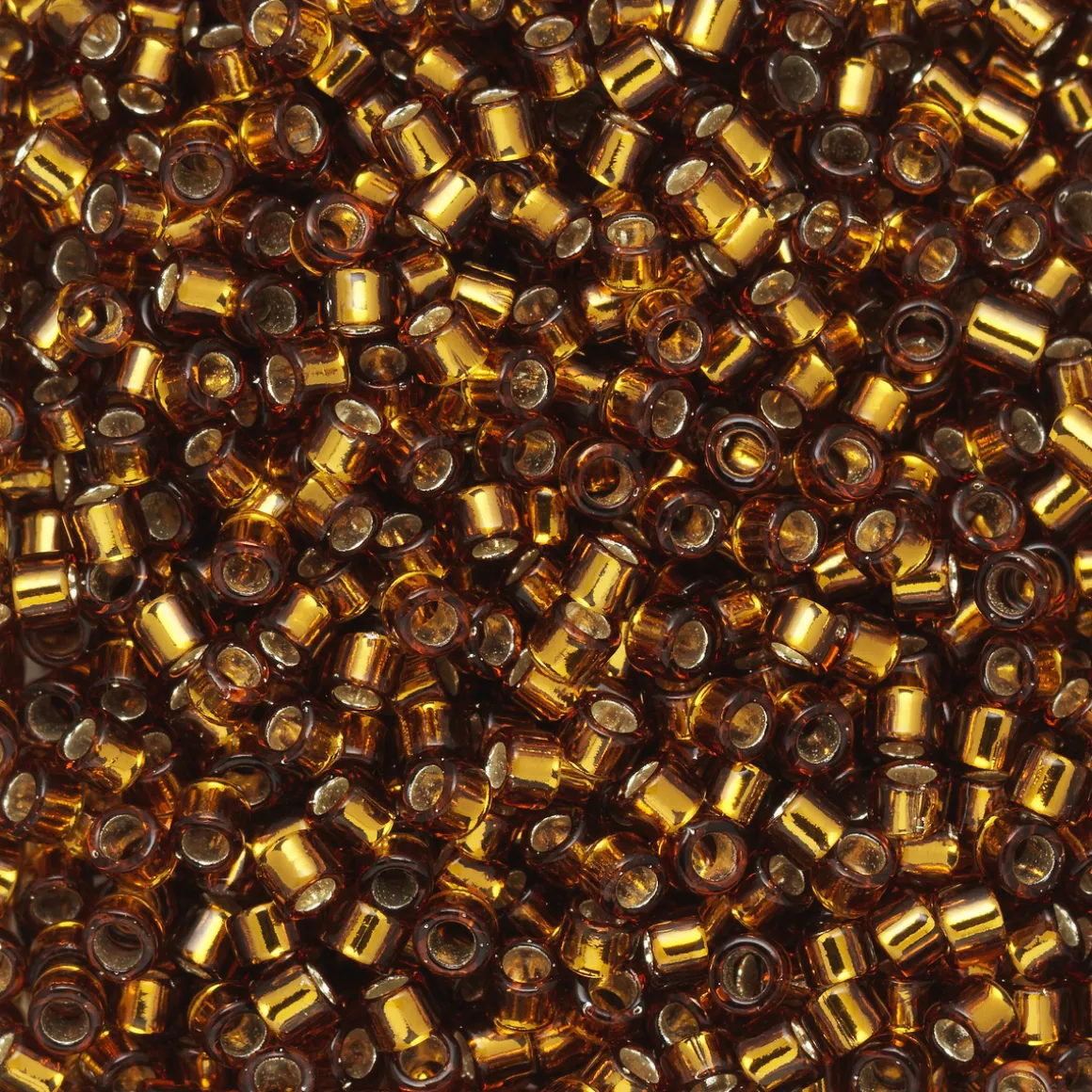 TOHO-perler 11/0 – brun silverline, 34 Silver-lined smoky topaz